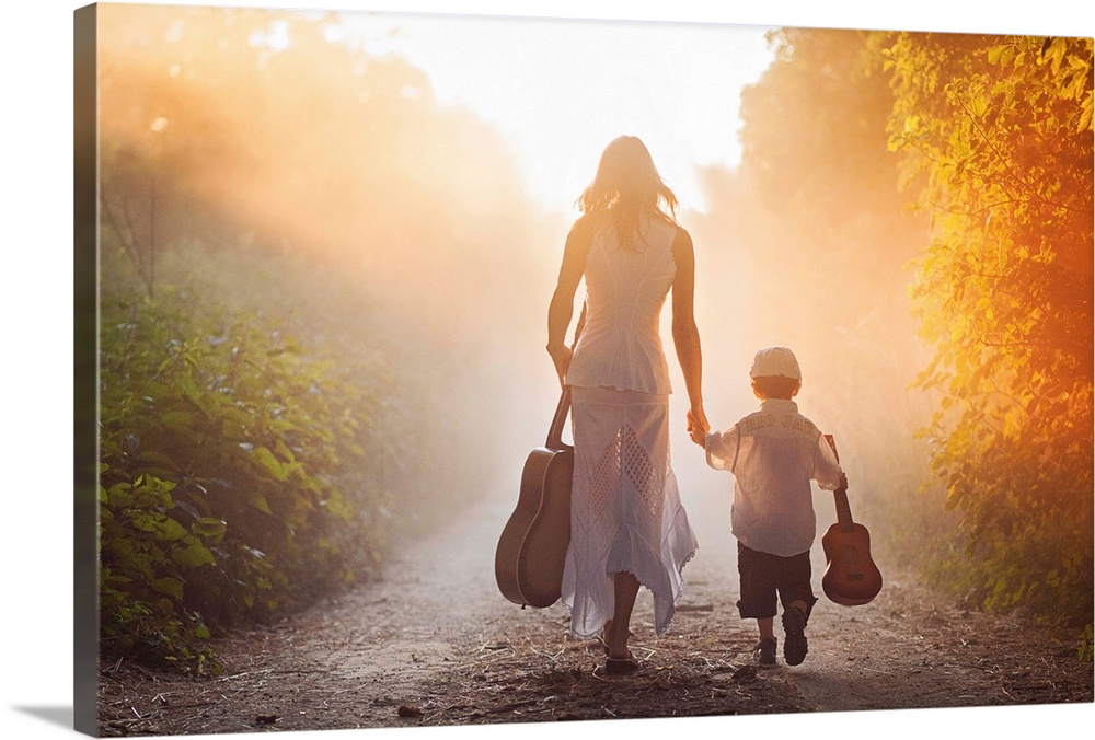 A woman and a young boy, each holding a guitar, walk down a path into golden sunlight.