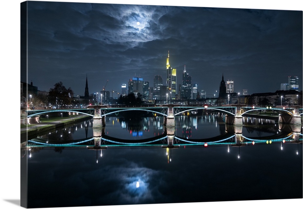 The moon glowing in the clouds over the Ignatz-Bubis Bridge in Frankfurt, Germany.