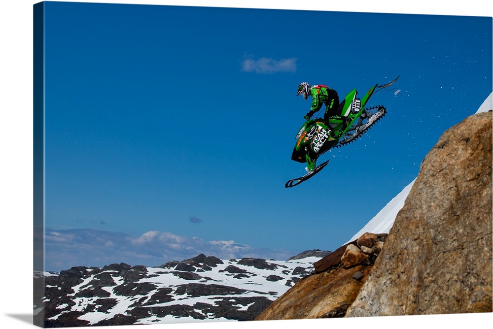 A snowmobile racer flying off the slope at Folgefonna Glacier in Norway.