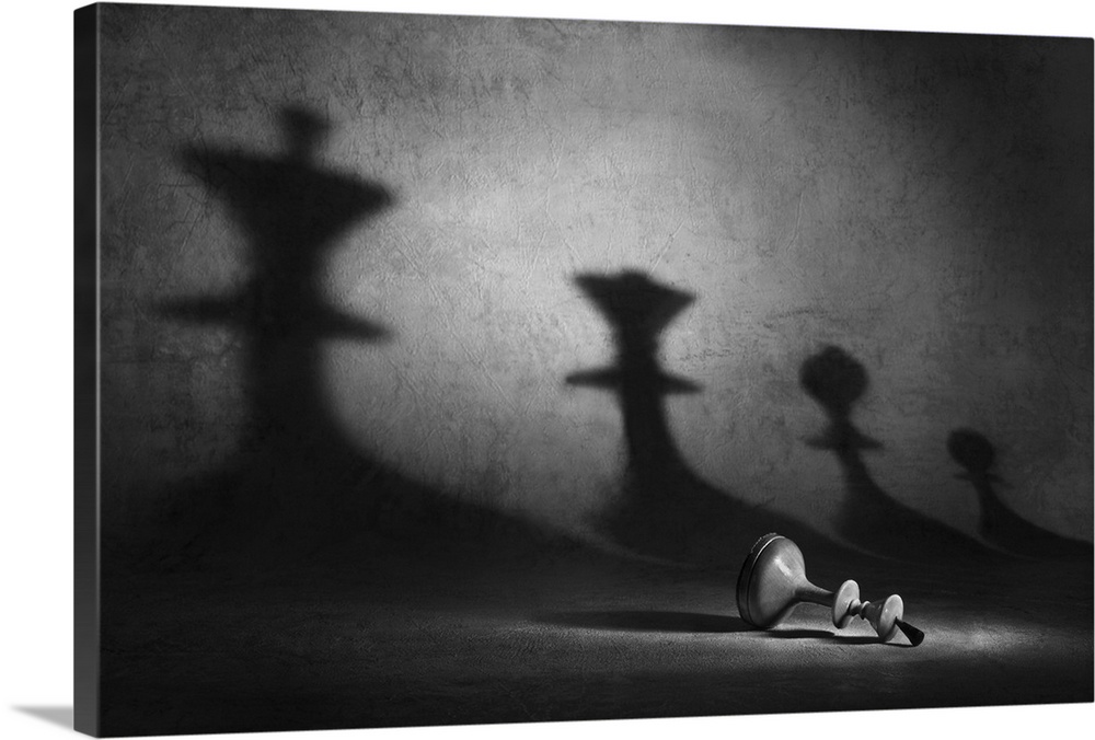A pawn laying on its side with shadows of other chess pieces looming over it.