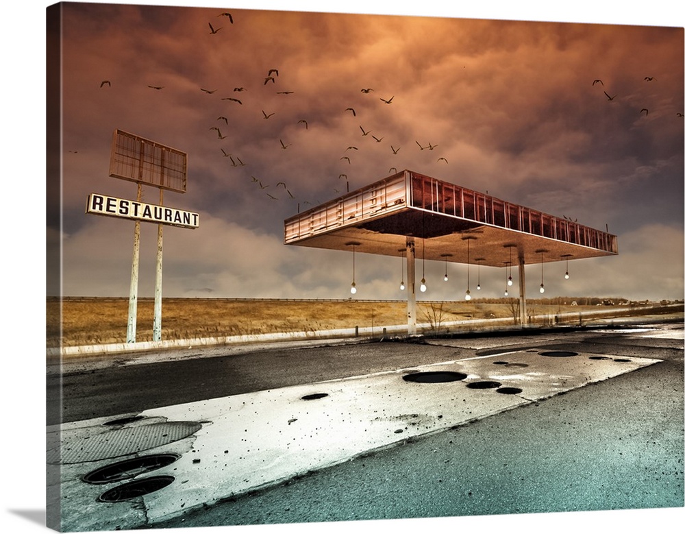An abandoned gas station pavilion under a dramatic an intense cloudy sky.