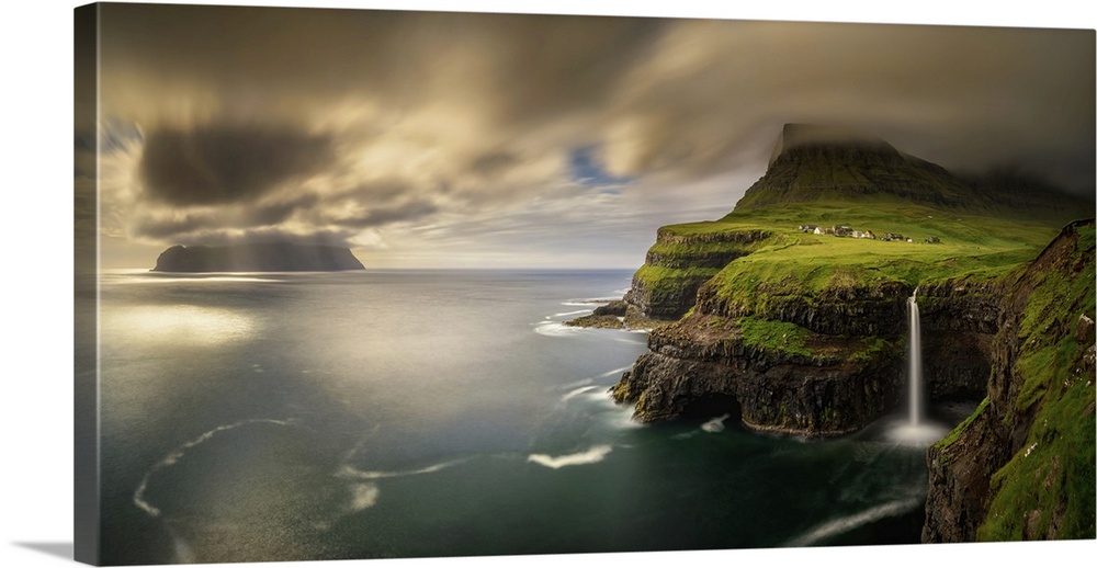 Panorama of Gasadalur village and cloudy Mykines island in sunset, Faroe Islands