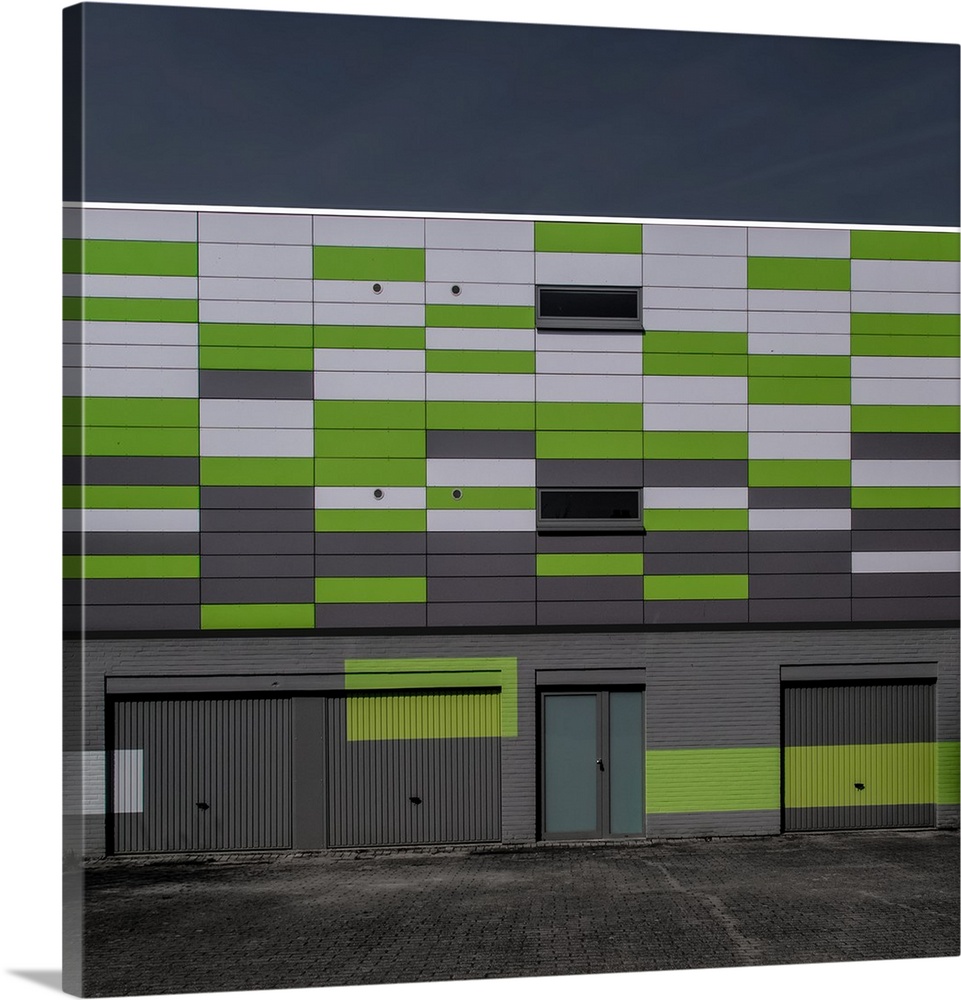 Green and white panels on the side of a building creating an interesting artistic effect.