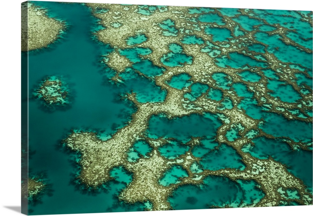 An aerial view over a turquoise lagoon.