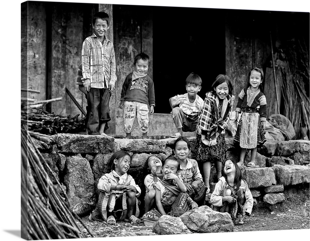 A group of smiling children standing in front of a house in Vietnam.