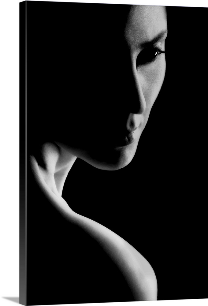 Black and white portrait of a woman with stark contrast between light and shadows.