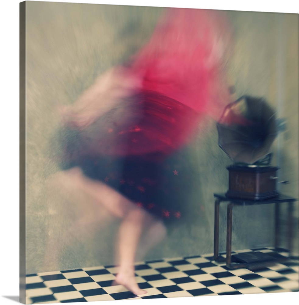 Blurred motion image of a woman in red dancing to music from a phonograph.