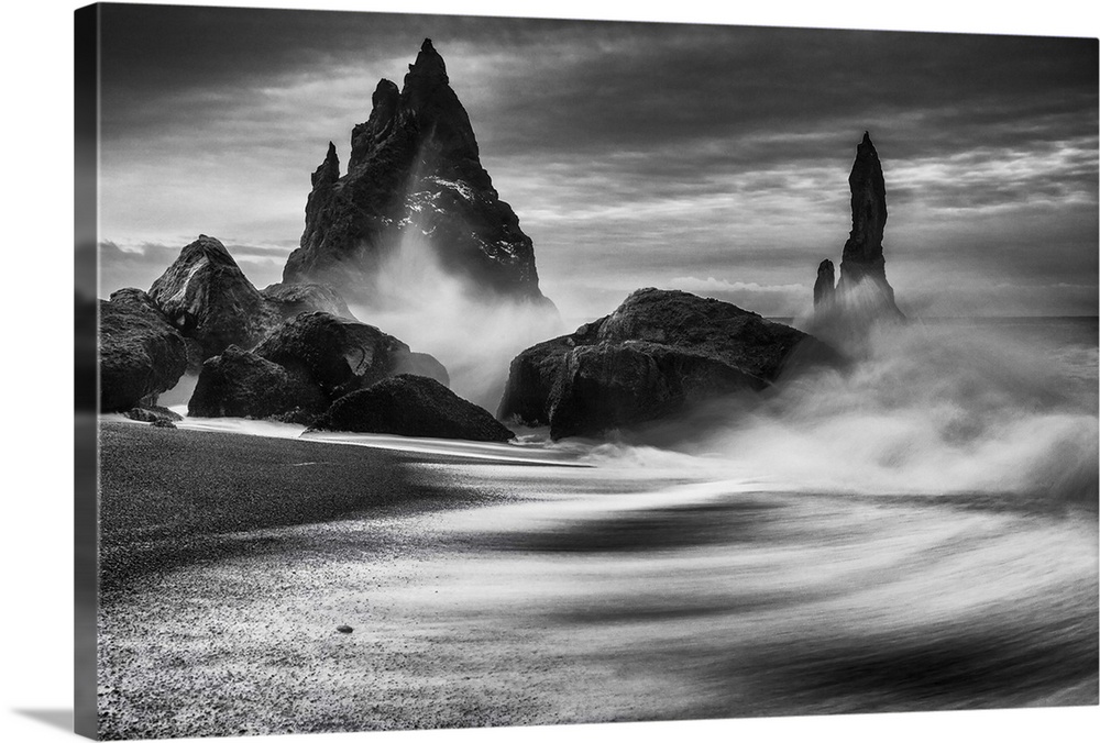 Waves crashing on tall rock spires in Iceland.