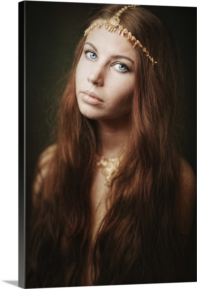 Portrait of a beautiful woman with long hair wearing a beaded headband.
