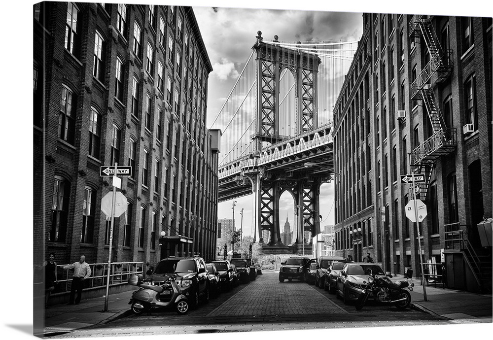 A tower of the Manhattan Bridge framed by urban buildings in New York.