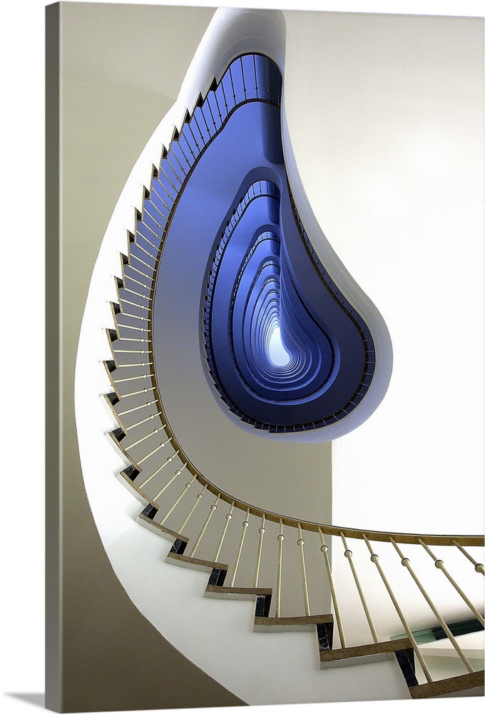 View from the ground of an oddly-shaped spiral staircase, with a blue glow.
