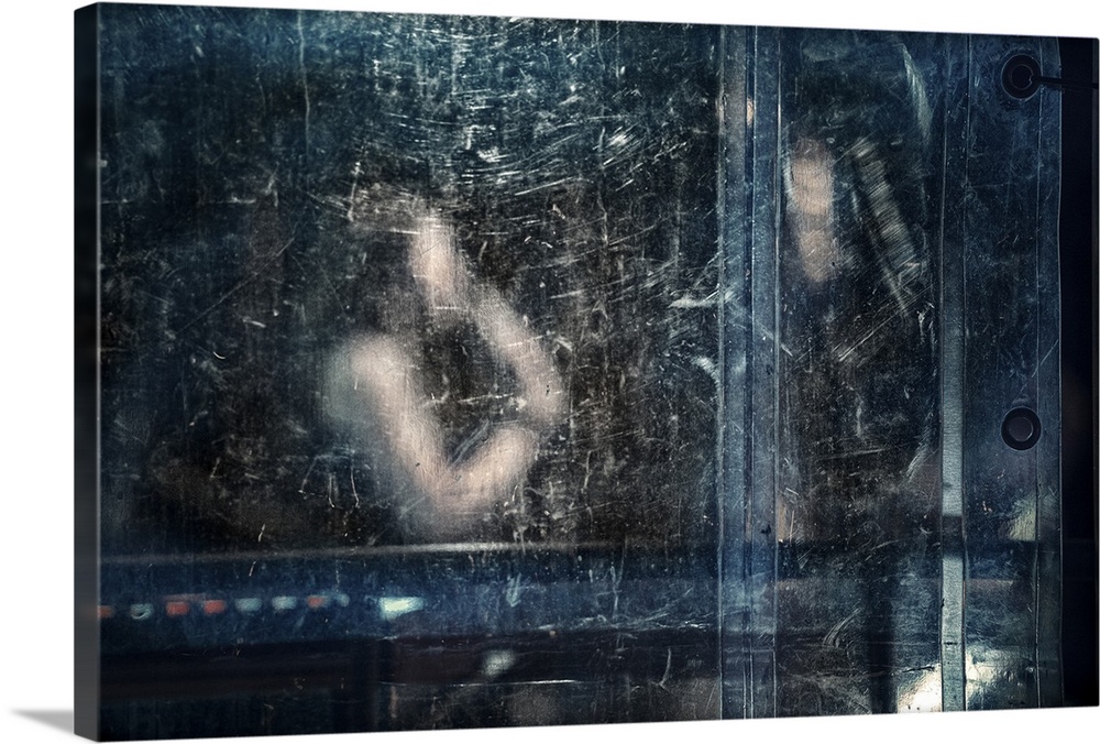 An abstract photograph of a figure behind a blue dirty and scratched screen.