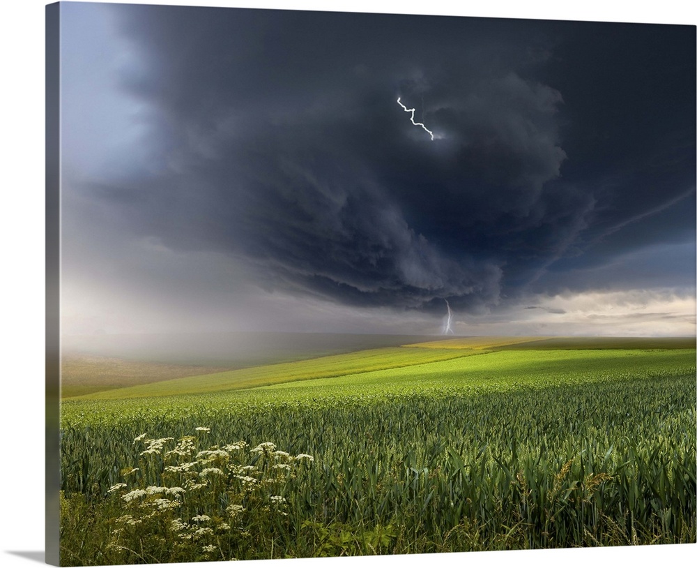 A dark storm cloud with lightning bolts over a field in the Swabian Jura region of Germany.