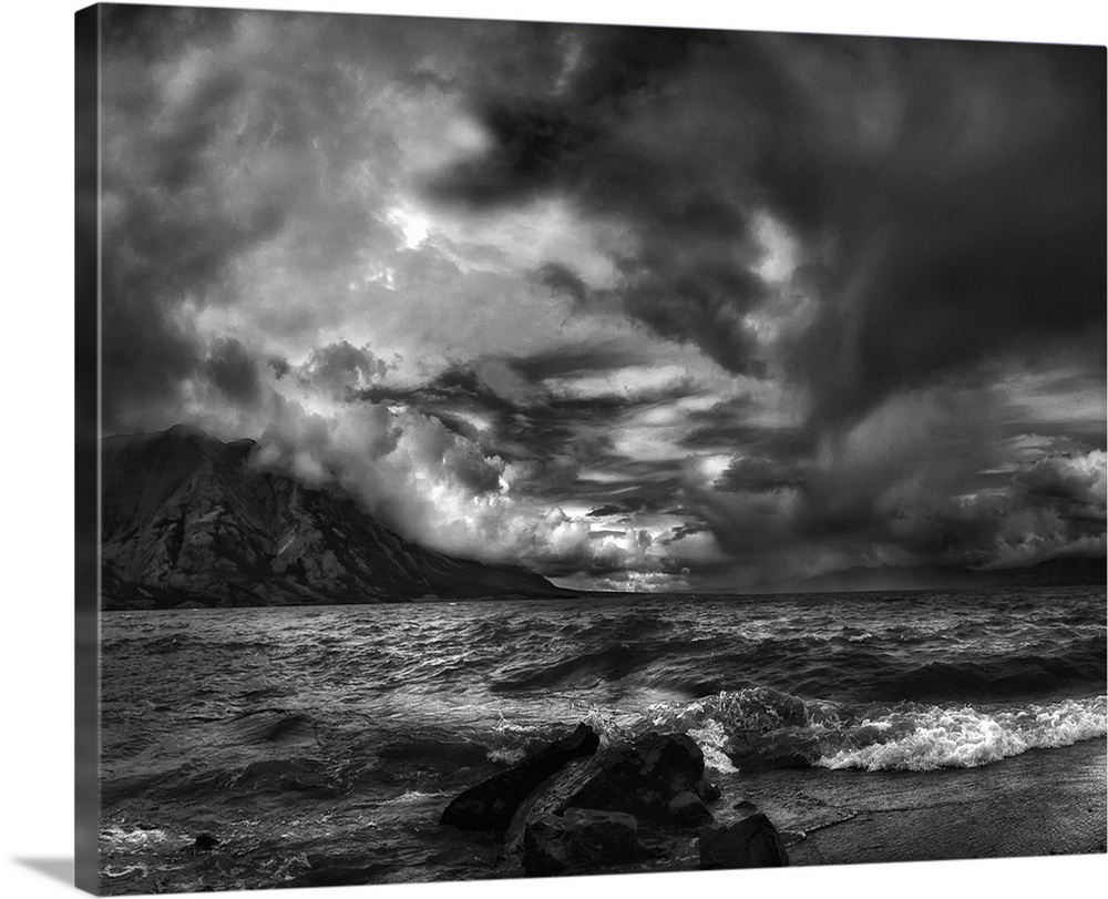 A seascape under a blanket of aggressive looking clouds.