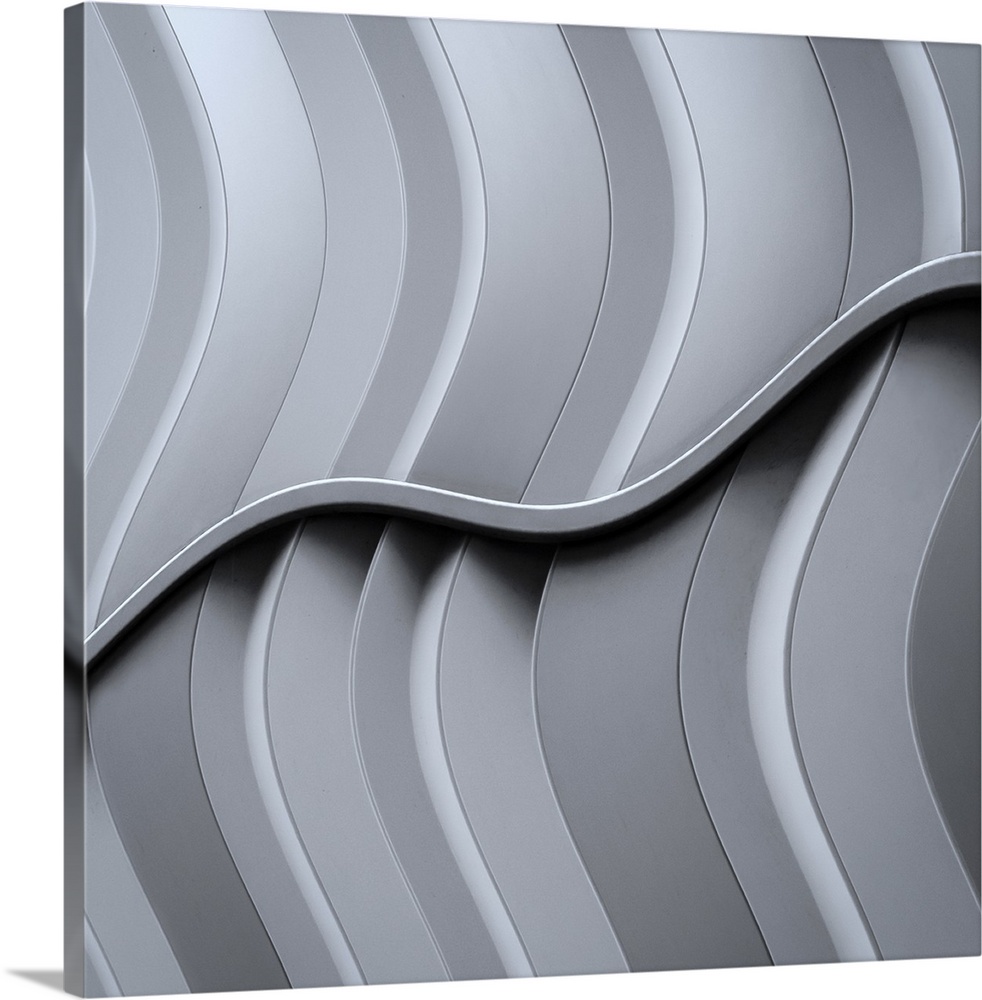 Abstract architectural image with intersecting curved metal panels.