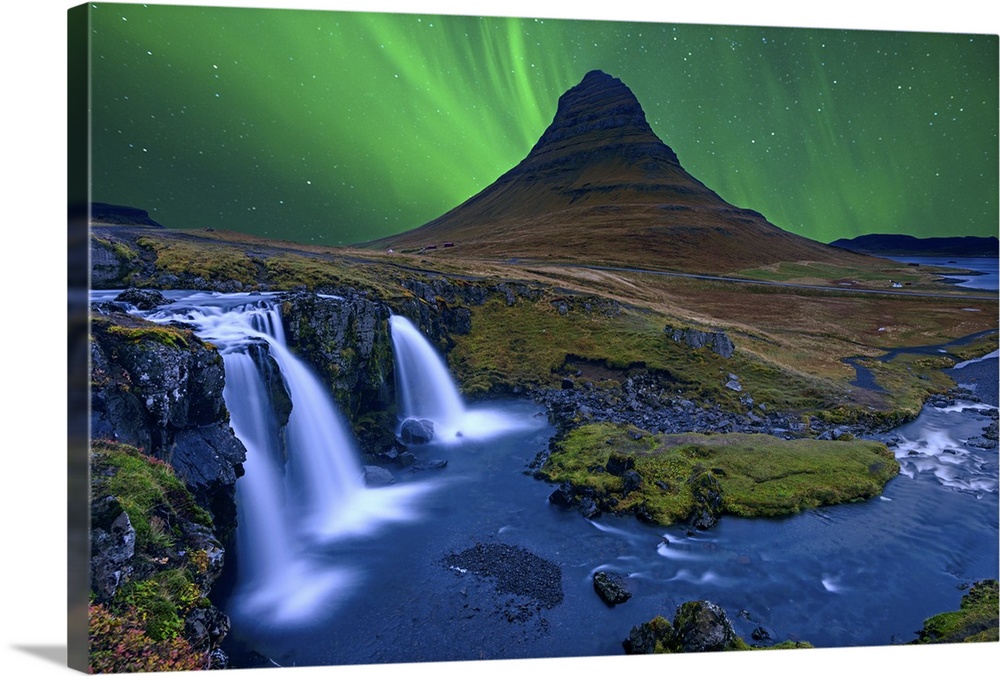 Northern lights over Kirkjufellfoss, with a stunning waterfall in the foreground.