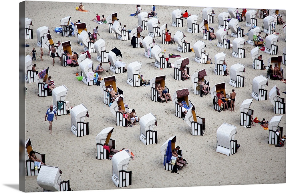 Rows of black and white cabanas on the beach, Italy.
