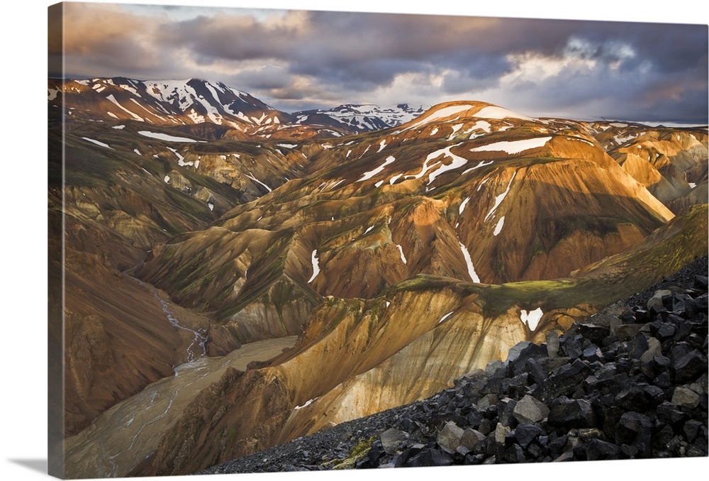 Mountain range with snow, lit up at sunset, Iceland.