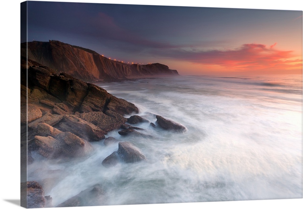 Rocky ocean cliffs over the sea at sunset, Santa Cruz, Portugal.