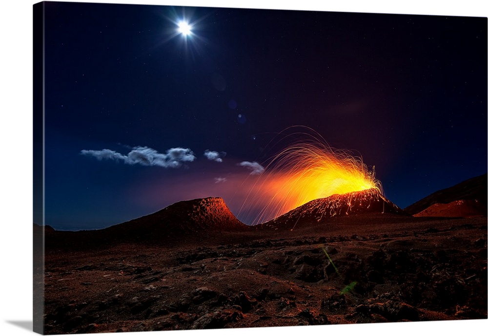 A volcano erupting at night in the moonlight on the island of Reunion, off the coast of Madagascar.