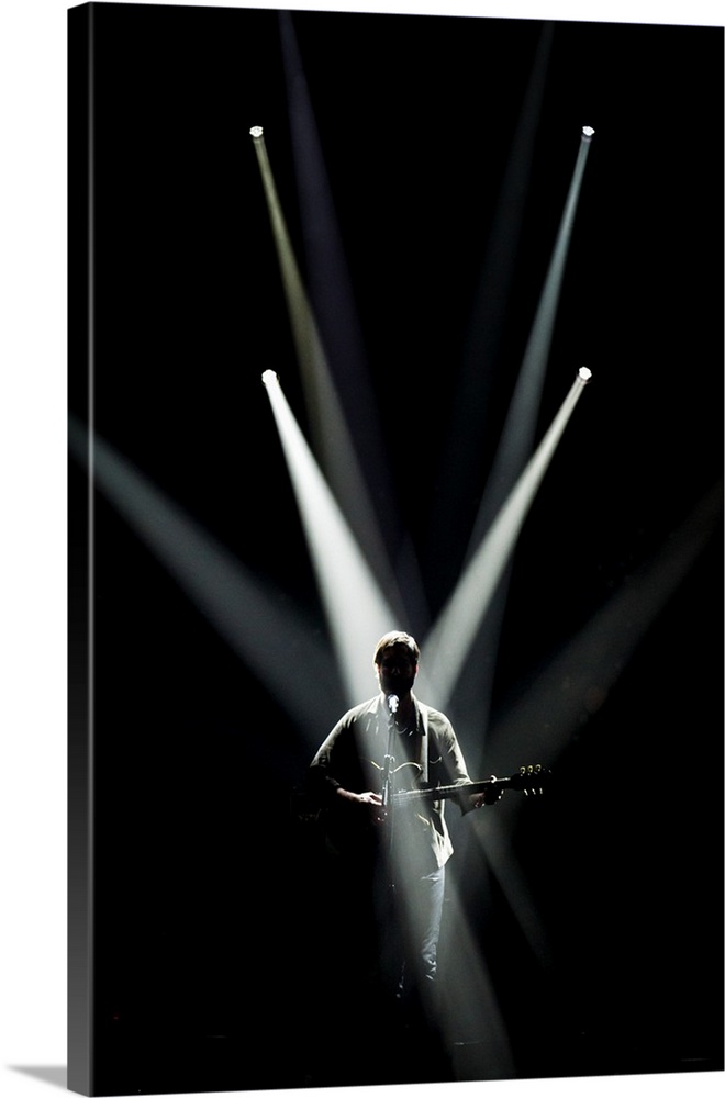 Spotlights on a musician playing on stage.