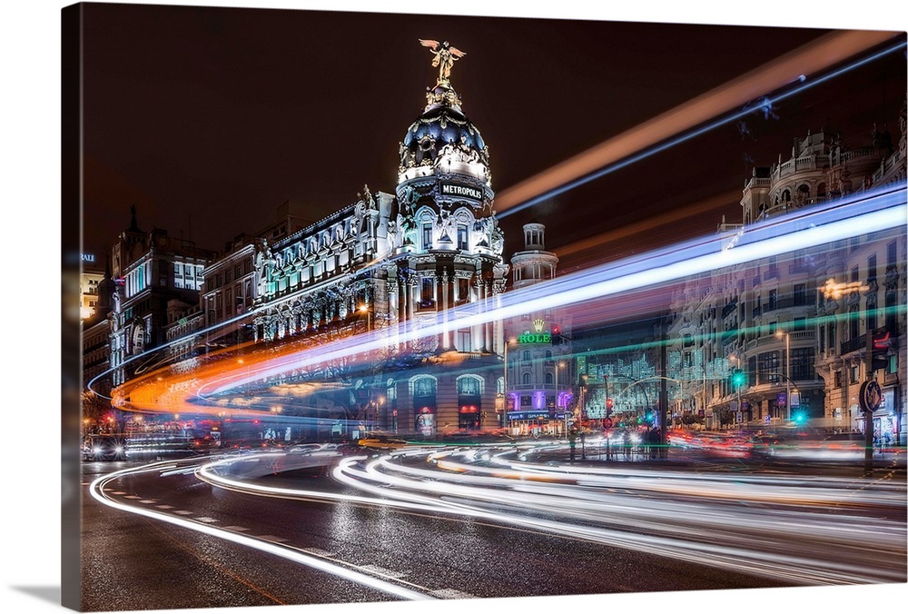 A night view of Madrid with neon light trails covering the air, Spain.