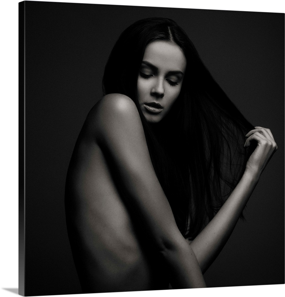 Nude portrait of a beautiful woman with long dark hair.