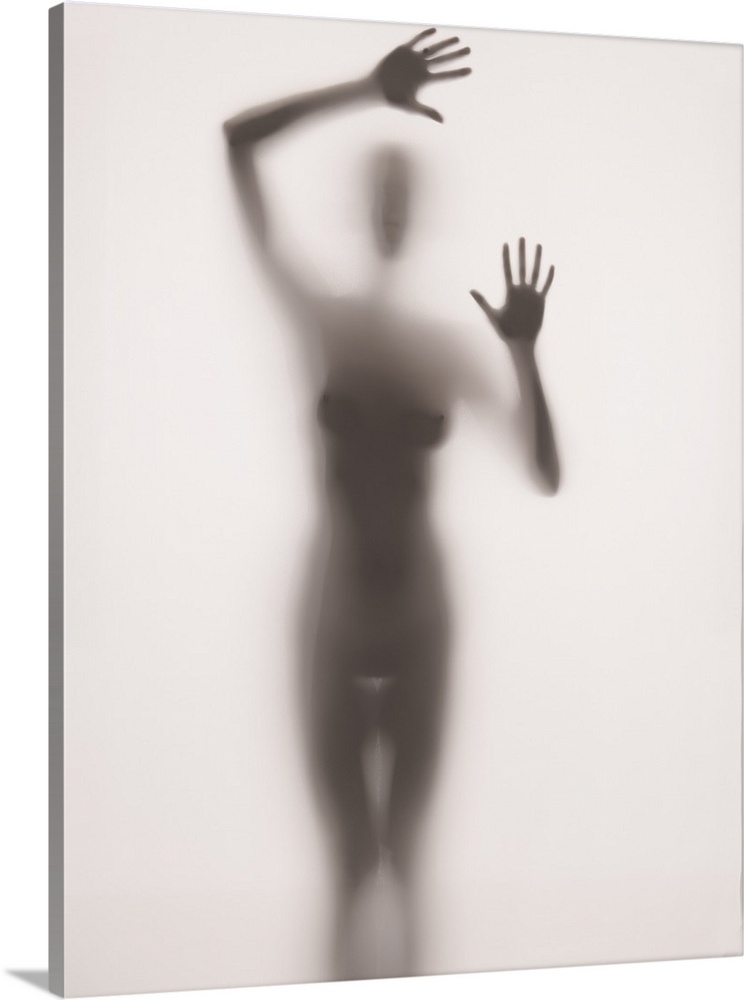 Fine art photograph of  nude female figure behind frosted glass.