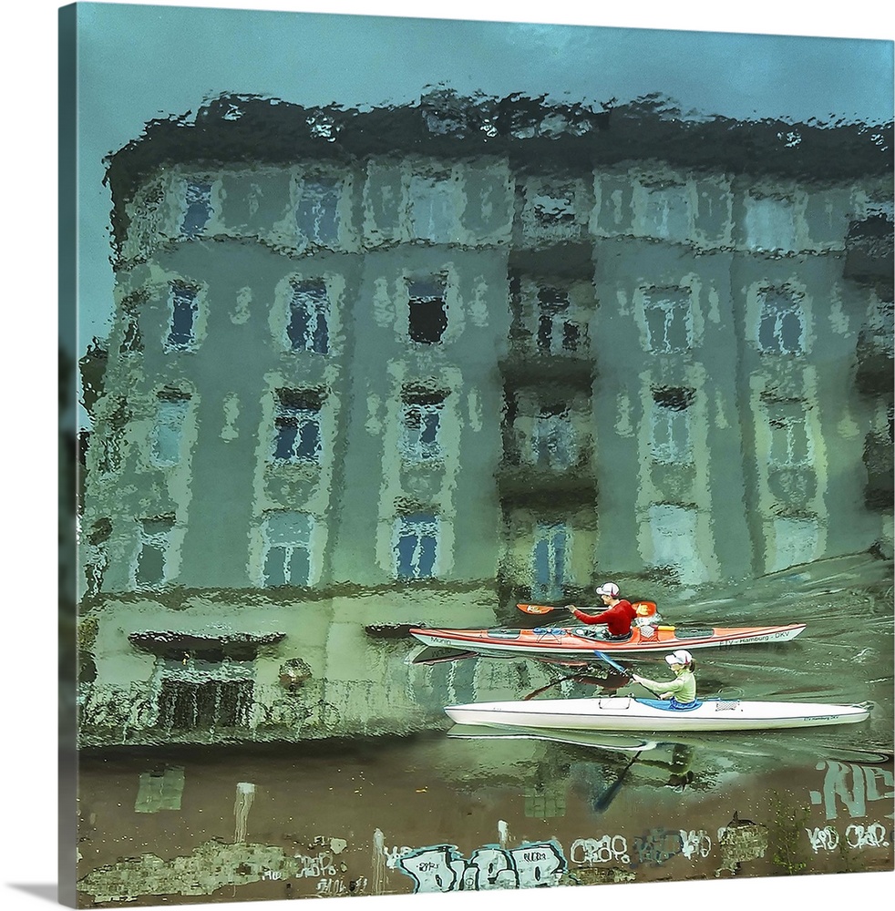 Buildings and graffiti of Hamburg, Germany, reflected in the water as two kayakers paddle through.