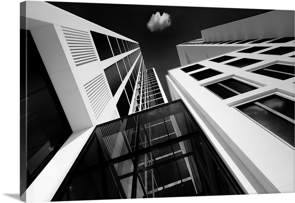 A black and white photograph looking up at tall skyscrapers in Germany.