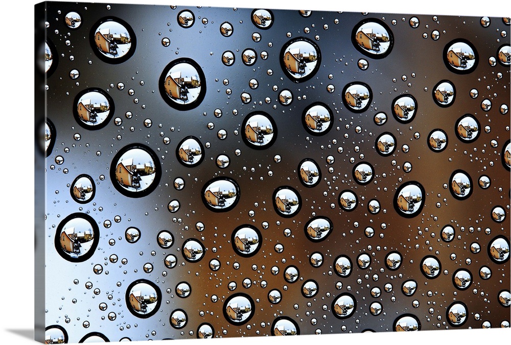 Image of a house reflected several times in tons of water droplets.