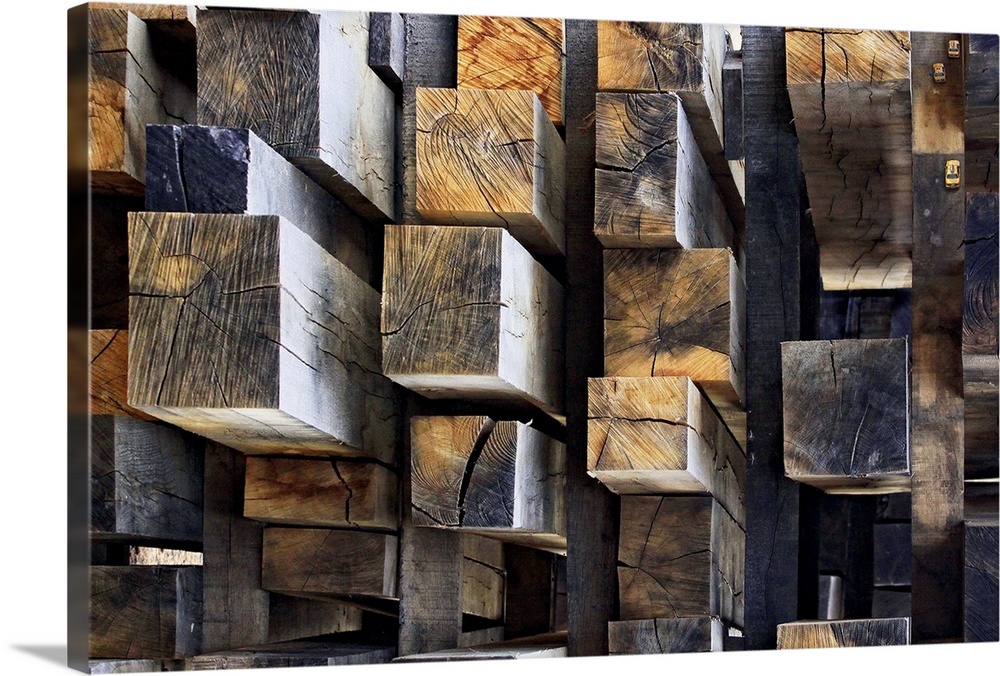 A stack of rectangular cut logs resembling an aerial shot of skyscrapers in a city. There are even small taxis in the uppe...