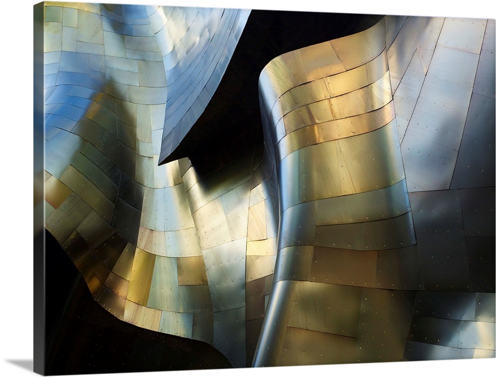 A photograph of an abstract view of a curved metal building facade.