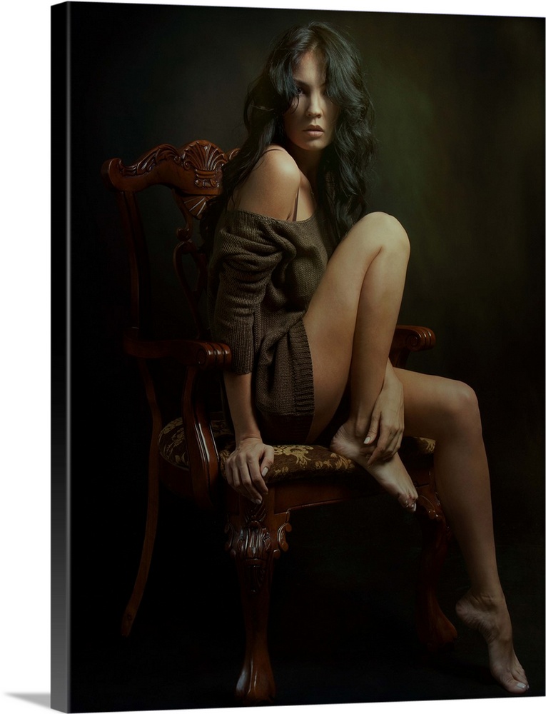 Portrait of a stunning woman with long dark hair in an ornate chair.
