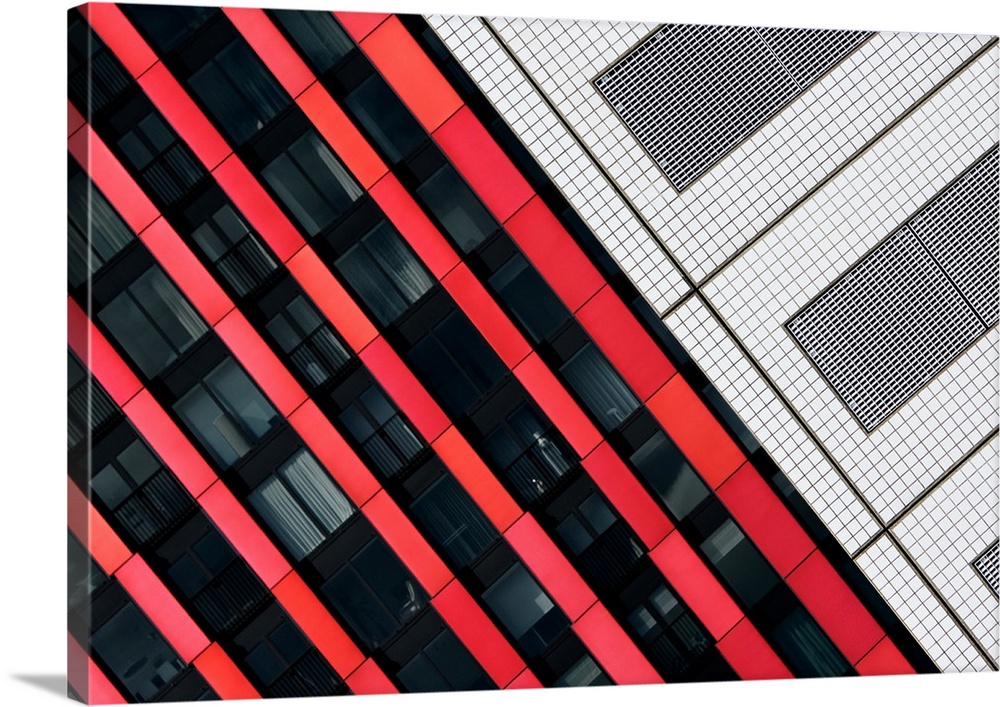Striking red panels contrasting with white tile on the side of a building.