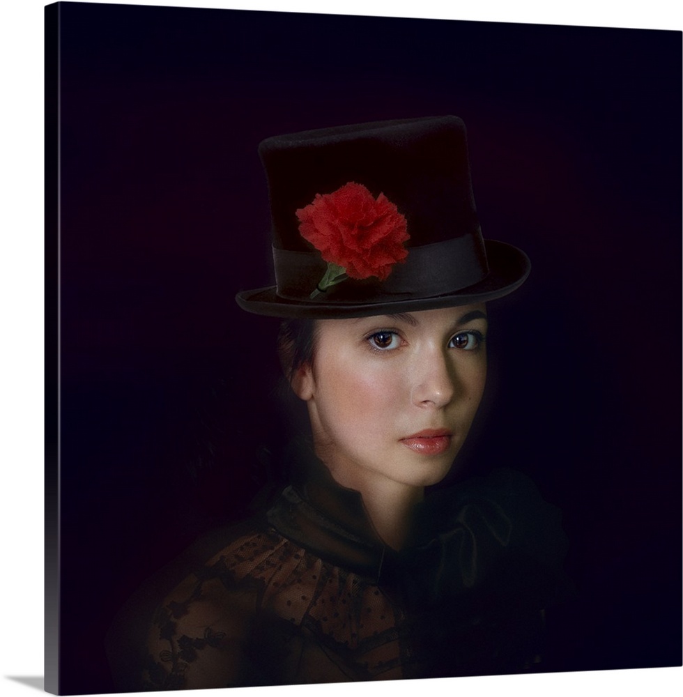 Portrait of a lovely young woman wearing a top hat decorated with a red carnation.