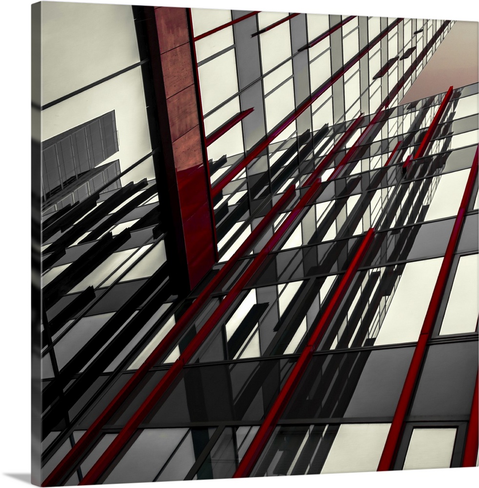 Abstract photograph of intersecting red and black panels and windows in a building.