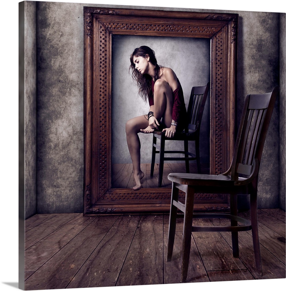 Conceptual image of a woman sitting on a chair in a large picture frame, with an empty chair in the foreground.