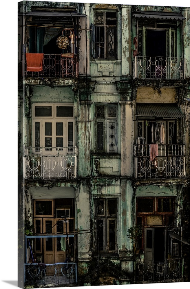 Iron railing and peeling paint on old balconies in an apartment building in Myanmar.