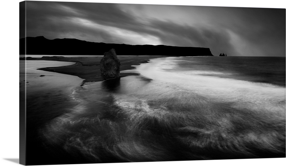 Low-key image of the tide coming in on the Icelandic coast.