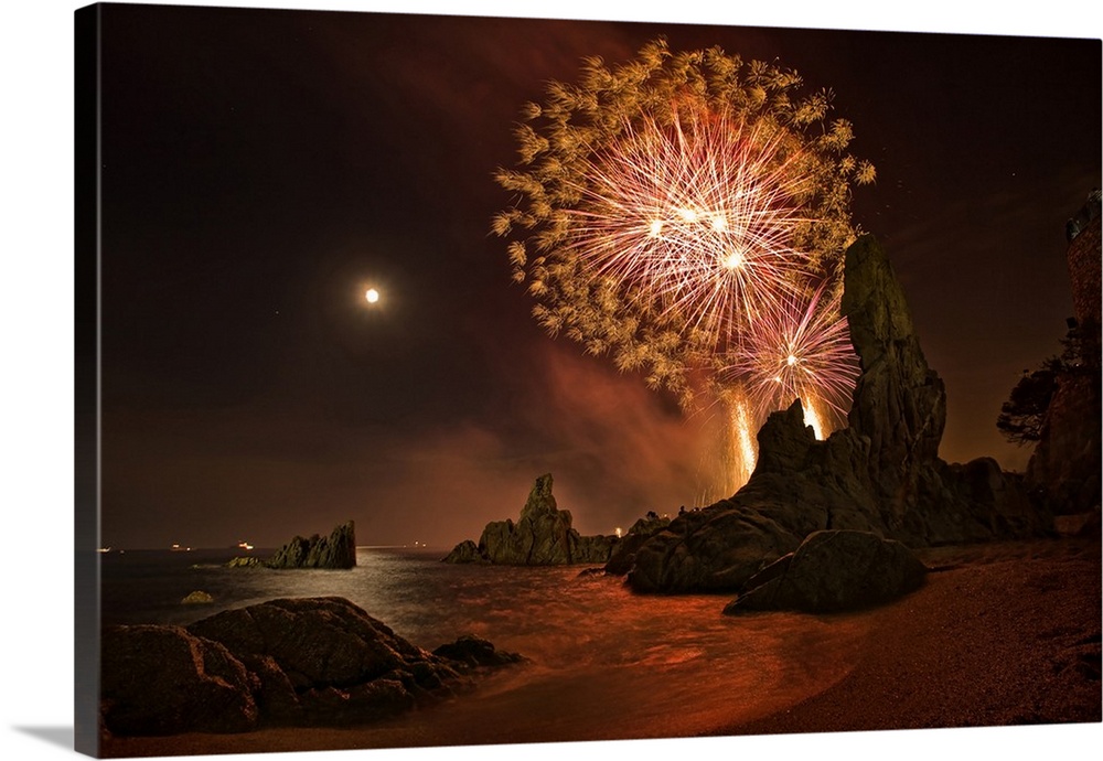 Fireworks over the rocky coast of Catalonia in Spain.