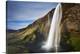 image thumbnail of A waterfall in a cliff with a rainbow, Seljalandsfoss, Iceland.
