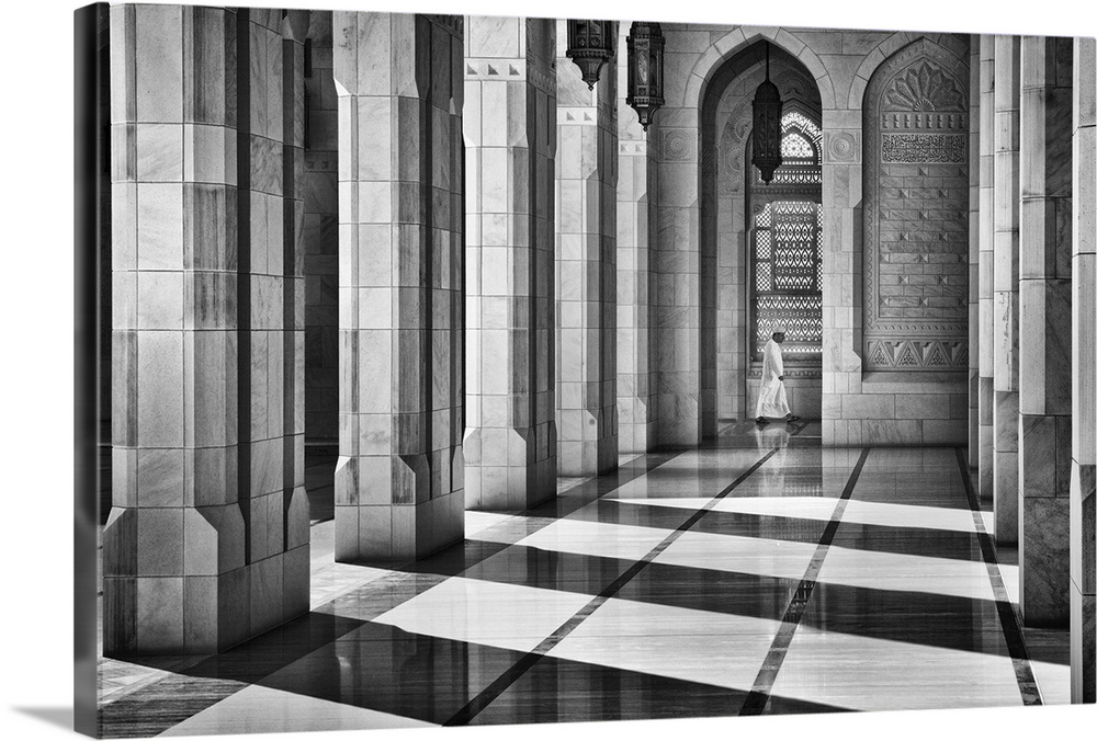 Dramatic shadows cast by intricate architecture of a mosque hit by sunlight, Oman.