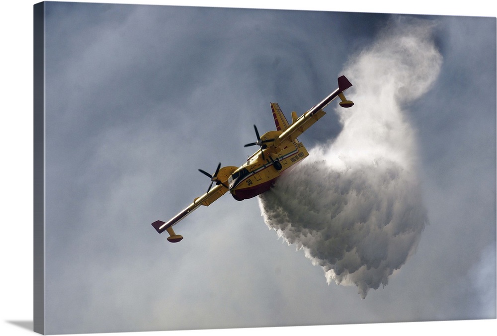 A CanadAir fire plane releasing tons of water in the sky.