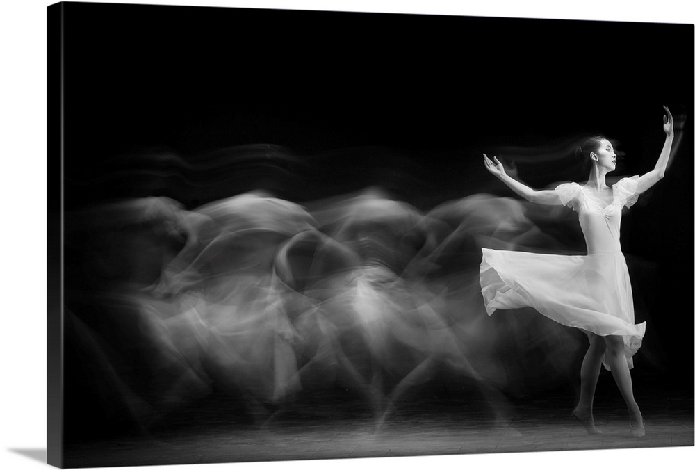 A black and white multi-exposure photograph of a dancer wearing a white dress.