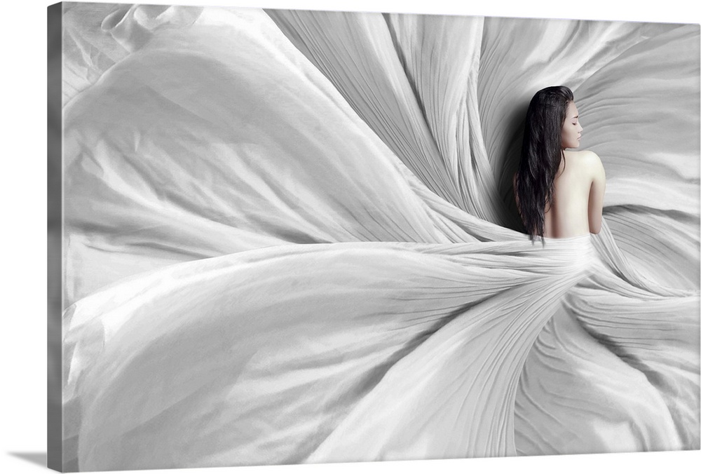 A woman wrapped in a white sheet which flows around her, resembling a flower.