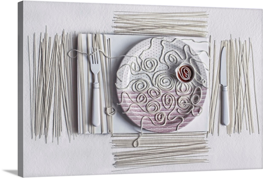 Conceptual photograph of a dinner table setting covered in white spaghetti noodles.