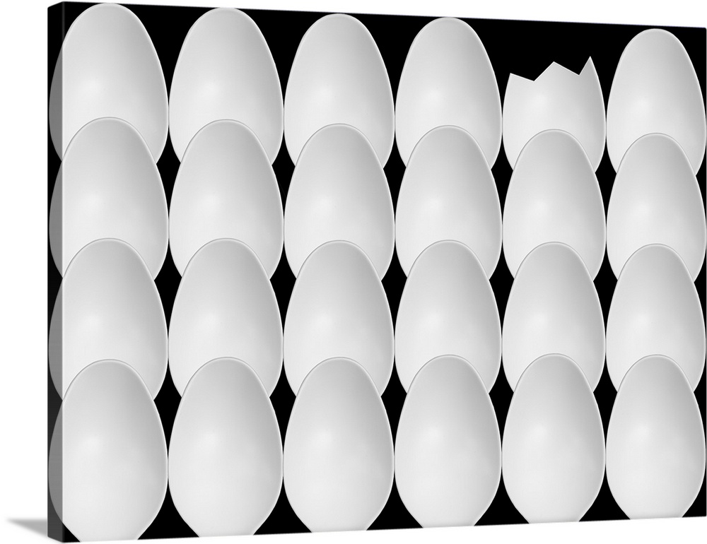 Abstract image of plastic spoons arranged to resemble a group of eggs with one cracked.