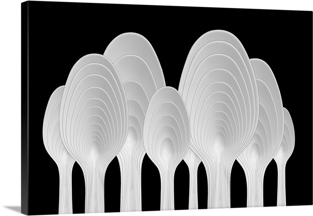 Abstract image of plastic spoons arranged to resemble a forest of ringed trees.