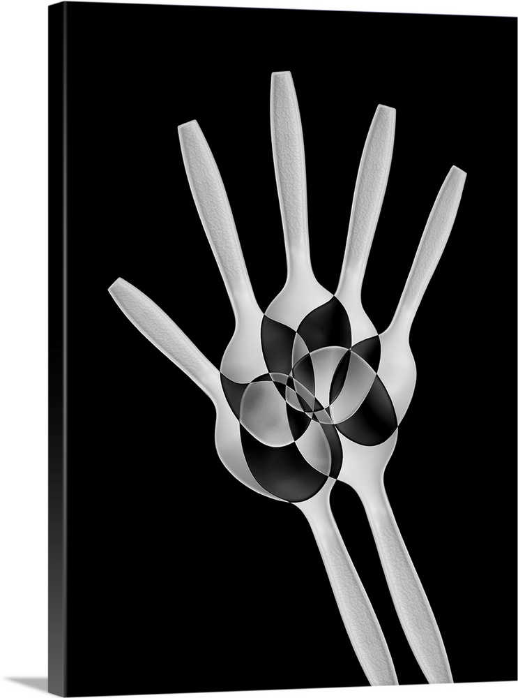 Abstract image of plastic spoons arranged to resemble the bones of a hand.